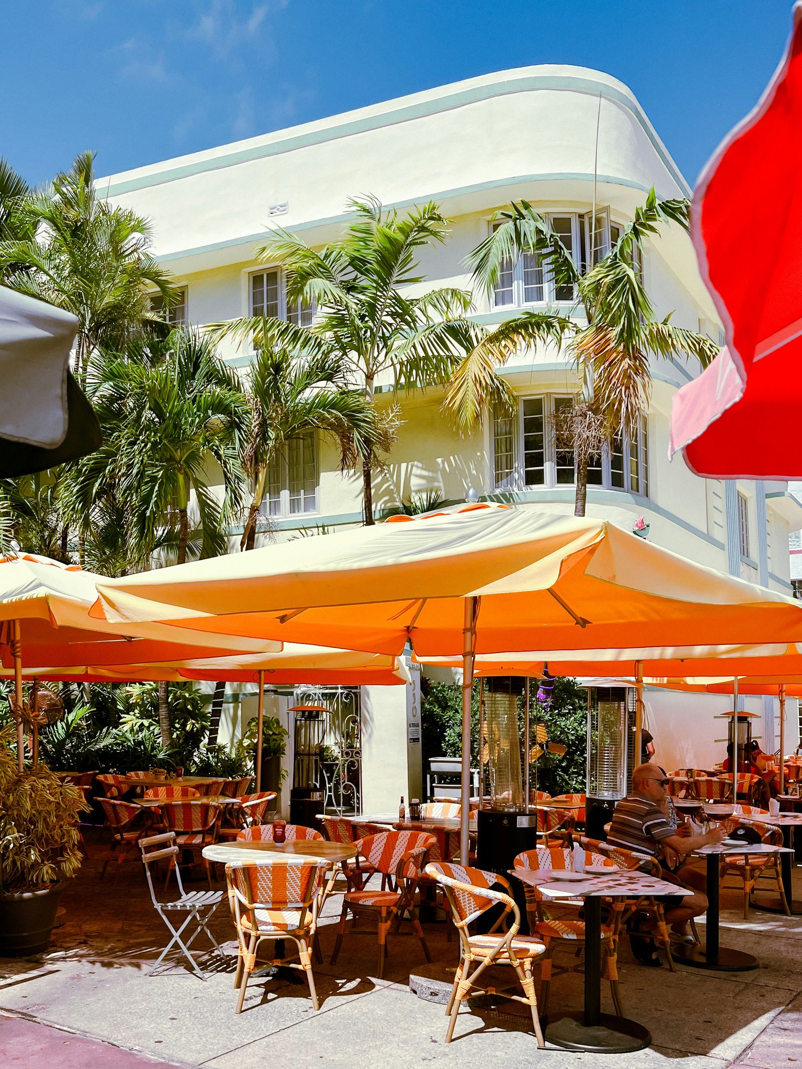 An outdoor dining area with tables and umbrellas