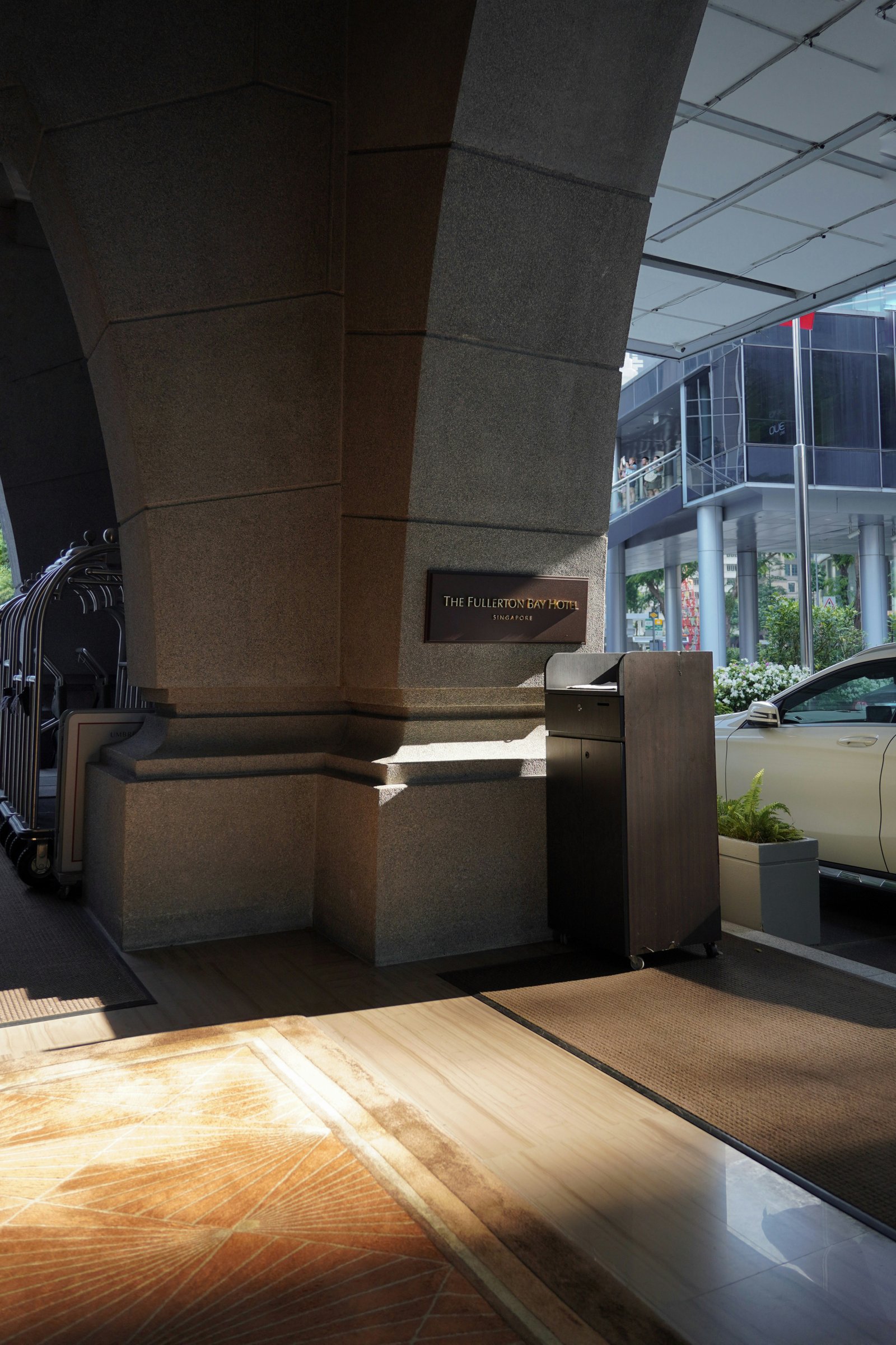 a car parked under a bridge next to a building