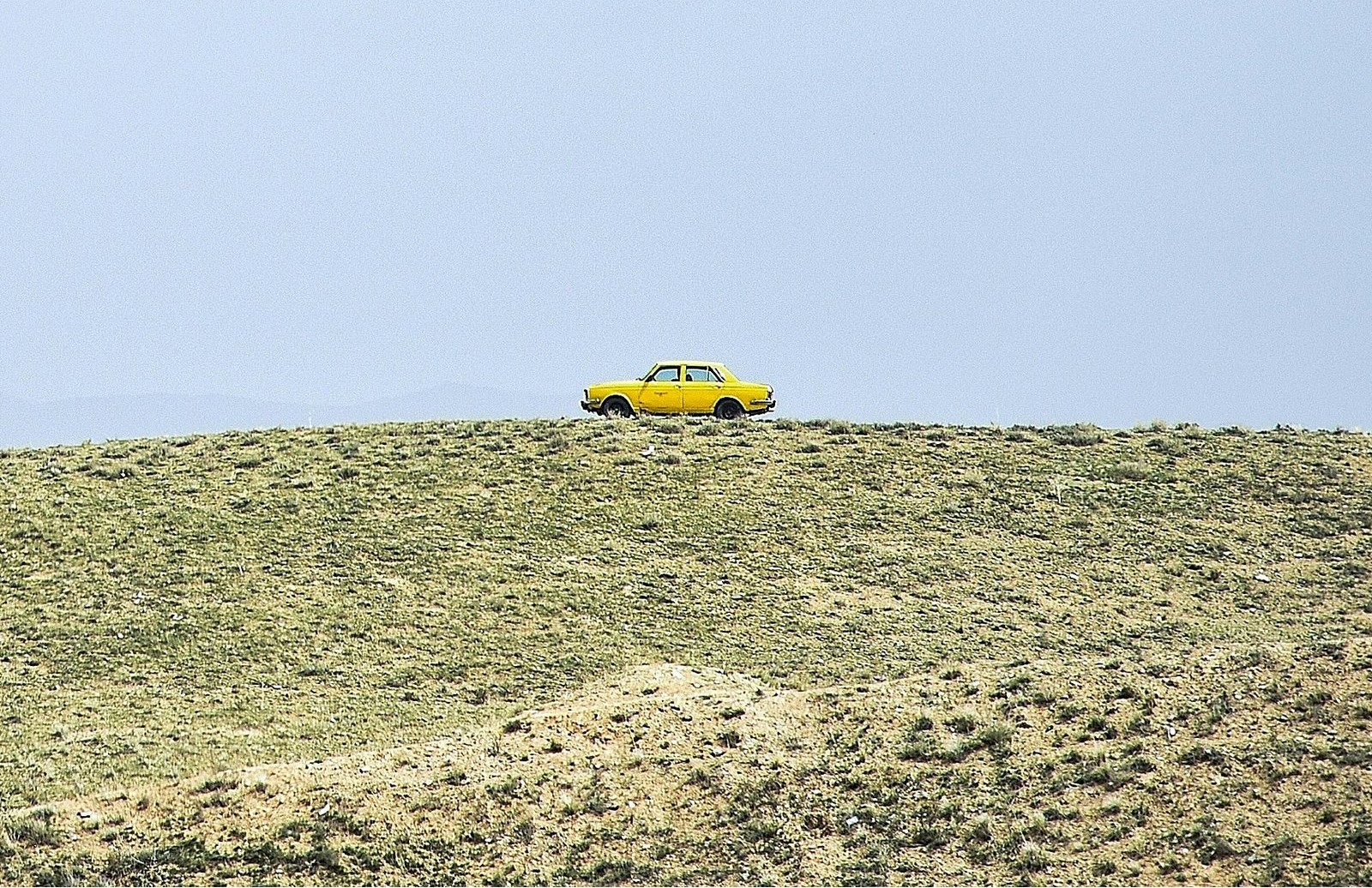 yellow sedan at daytime